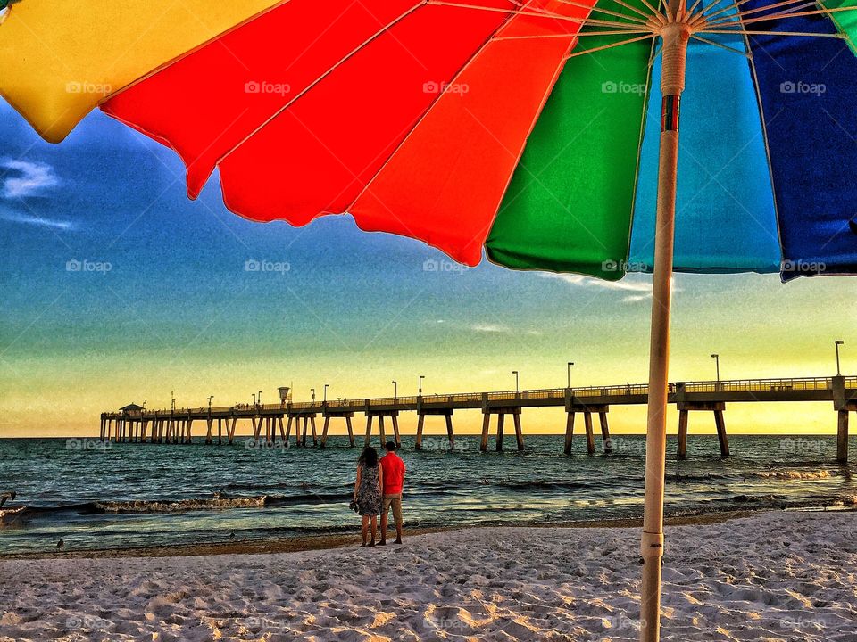 Rear view of couple standing on sea shore
