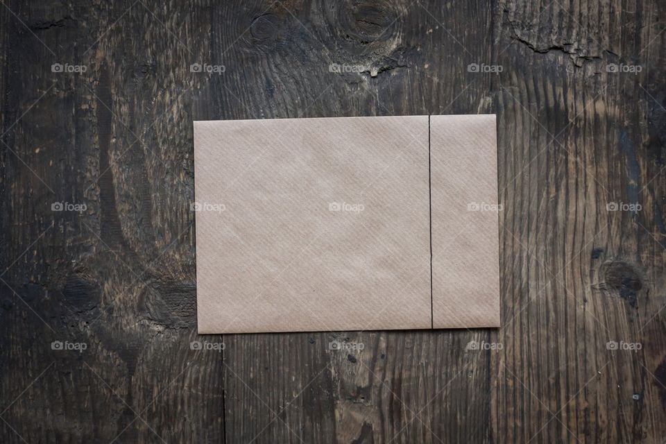 Brown envelope on wood background 