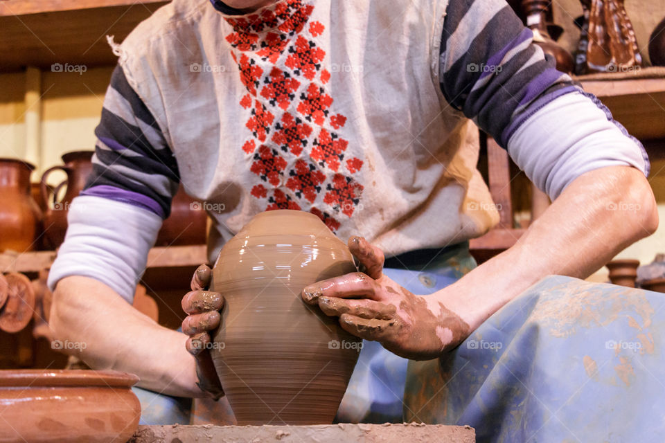 Potter is sculpting from clay