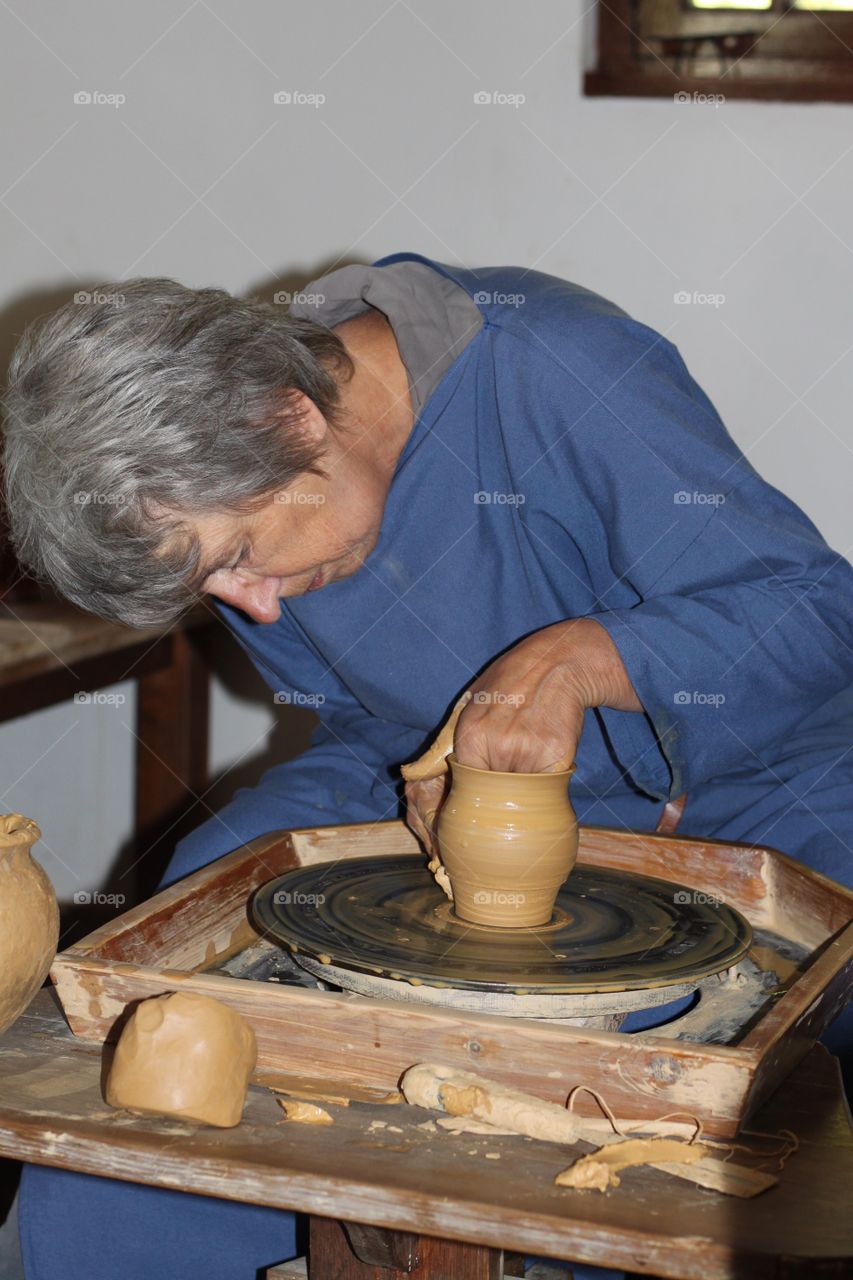 A potter is making a pot