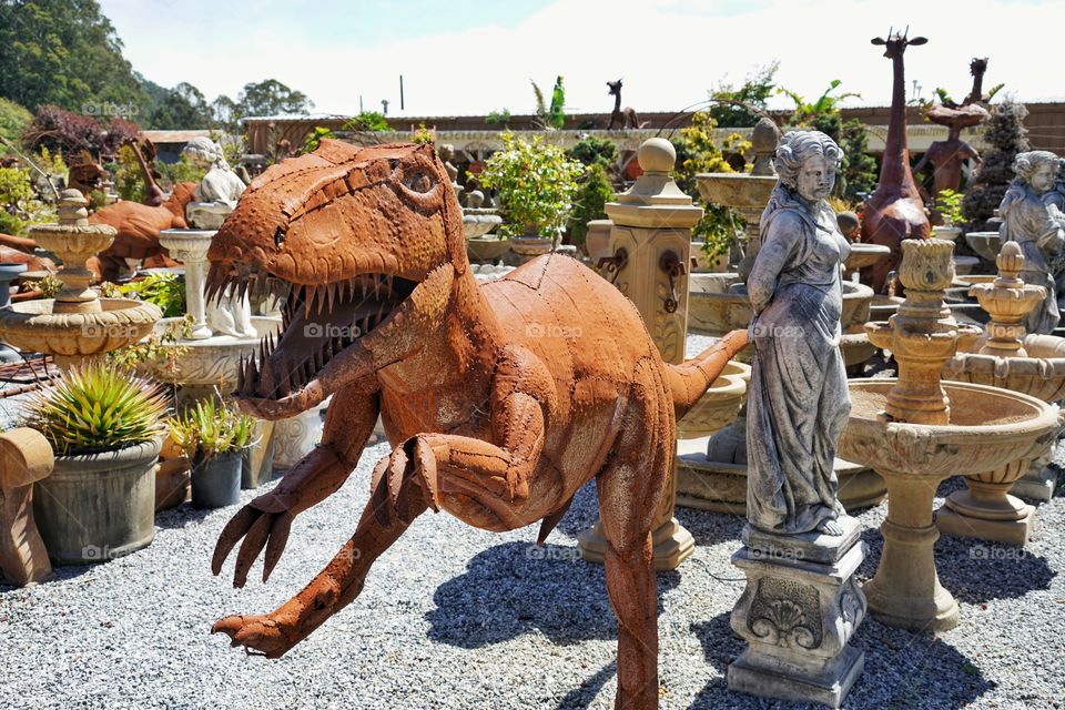 Dinosaur Statue In A Sculpture Garden
