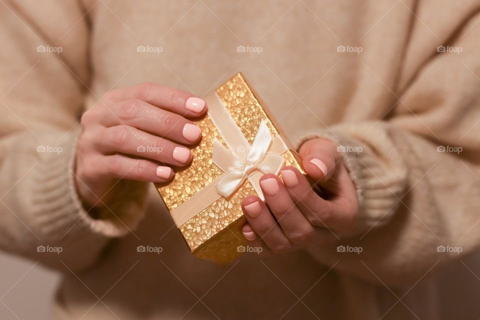 The person holding a gift box.