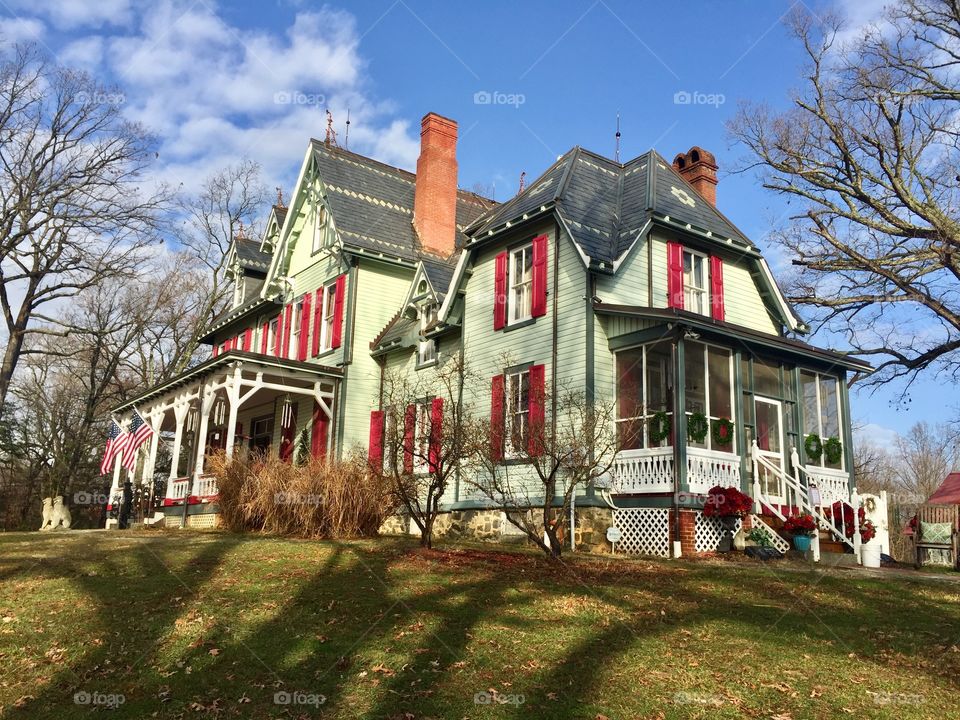 Victorian home with red shutters 