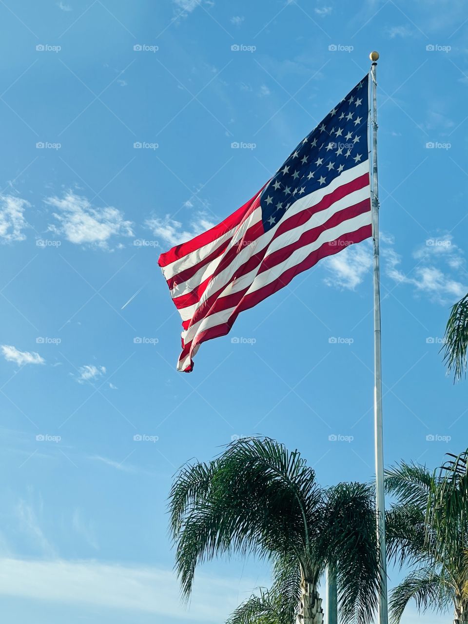 The big American flag with the sky background 