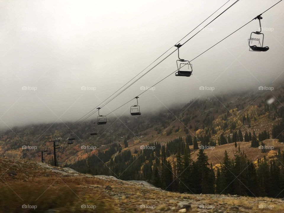 empty chairlift with an Autumn background in the Rocky mountains