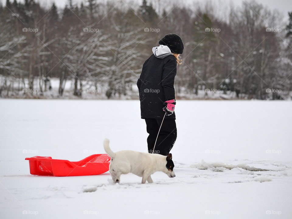 Girl and dog in the snow