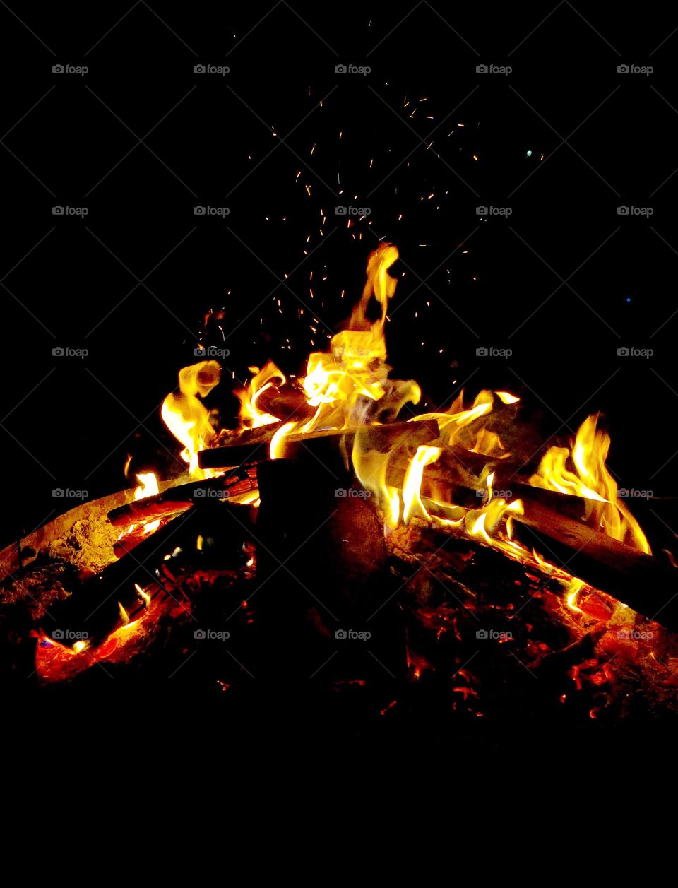 A warn crackling fire at night
