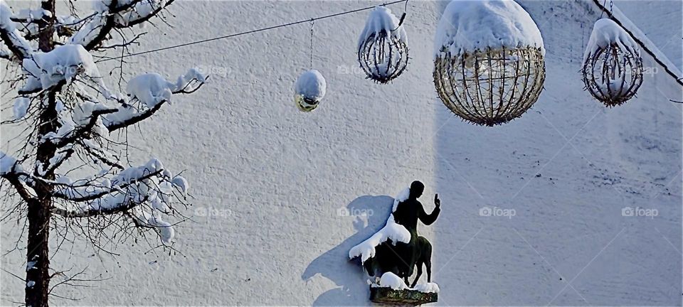 This is the „Christuskirche“ in „Straubing“, „Bavaria“, Germany with a statue of Jesus riding in on a donkey on Palm Sunday he was so convincing. Snow covered Christmas decorations are remnants of the blizzard of December 2023. Hypnotic Productions