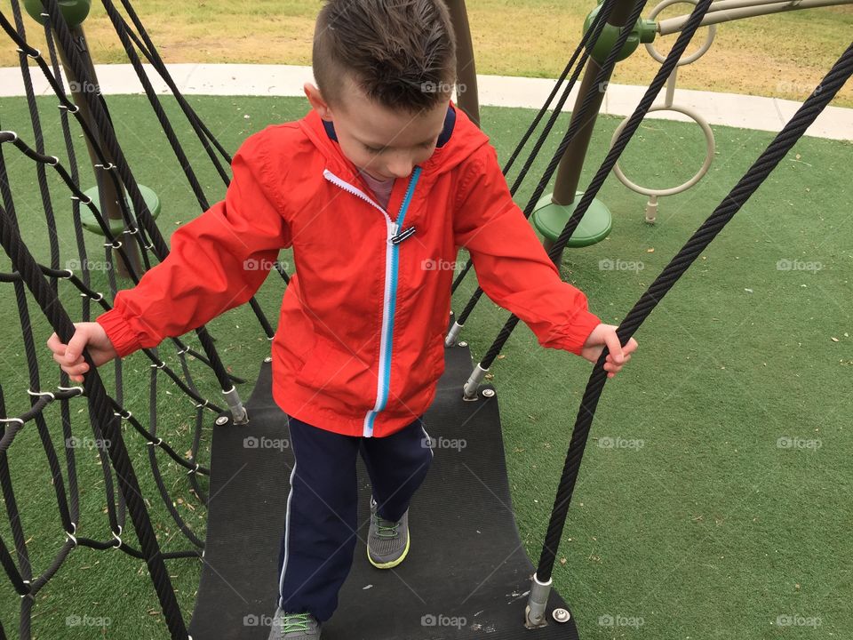 Boy playing on playground 