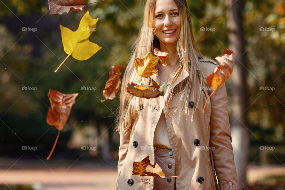 Happy woman in autumnal park