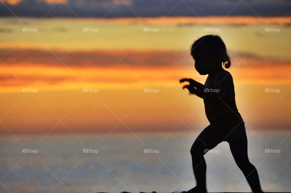 Child on beach at sunset