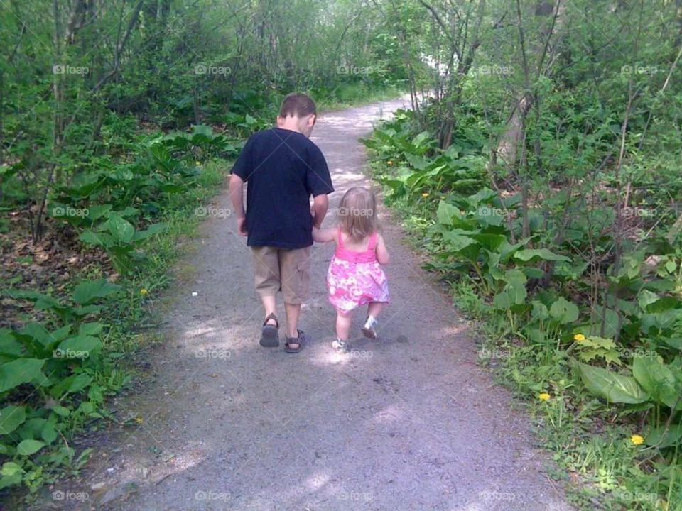 Brother and sister walking the trail 