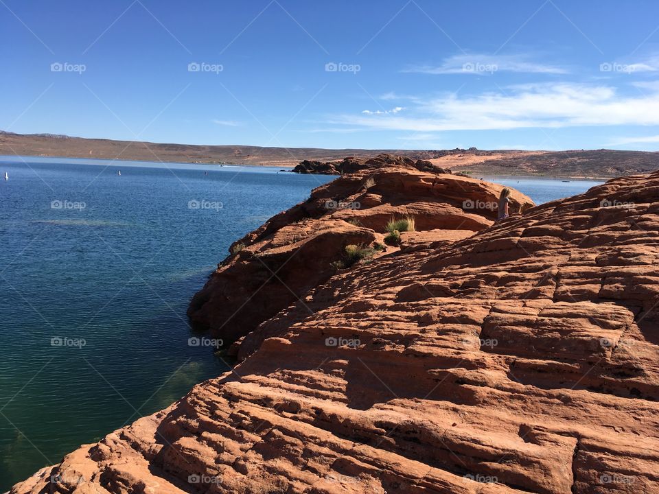 Red rocks jetting out into the water 