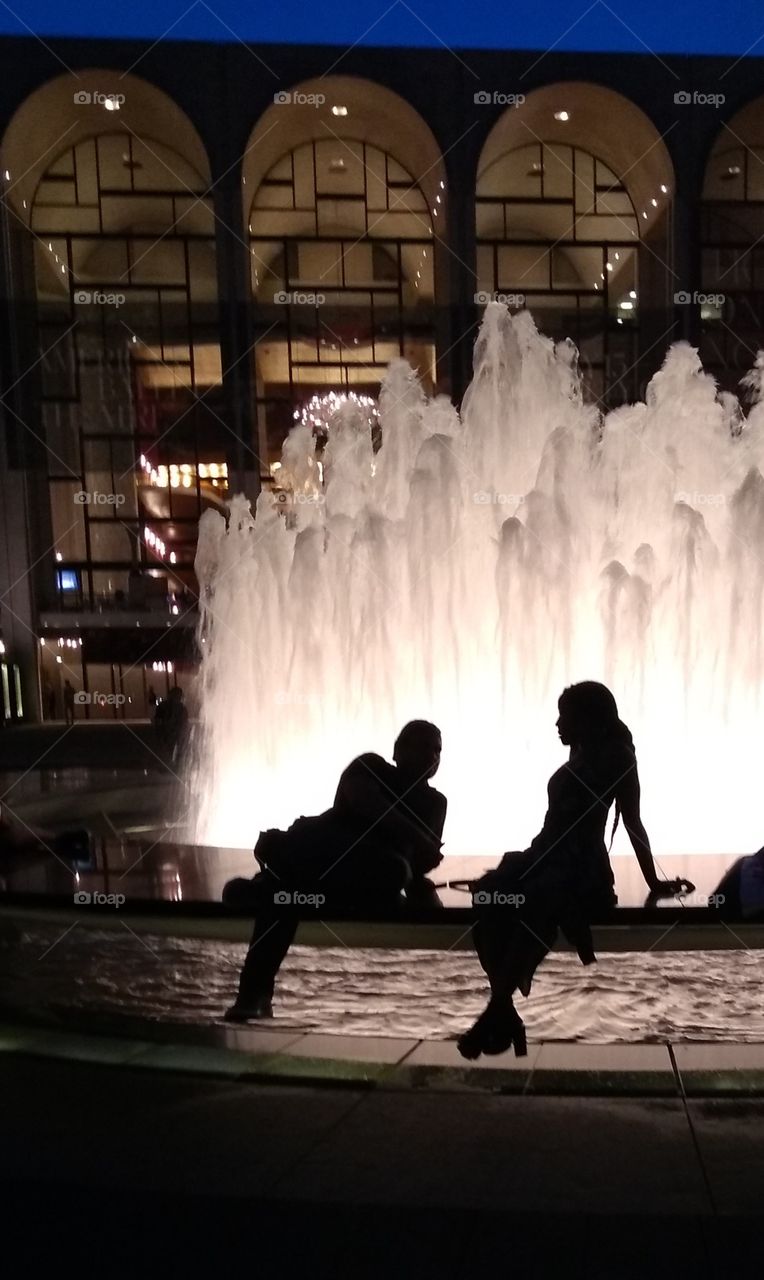 Backlit Couple in front of Fountain