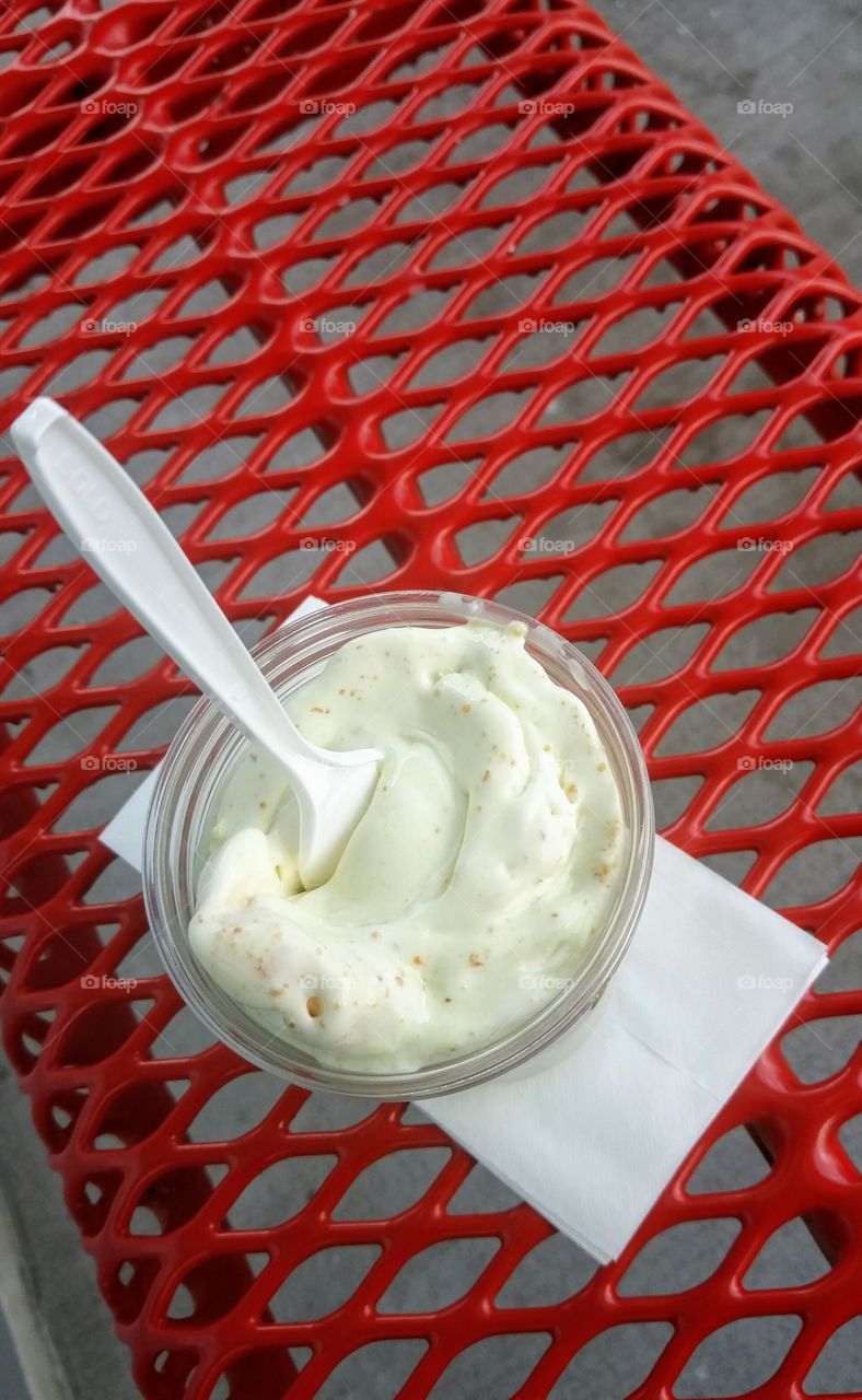 custard in a cup on red bench