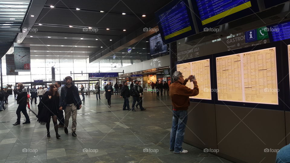 Man is looking at info deck at the railway station in Prague