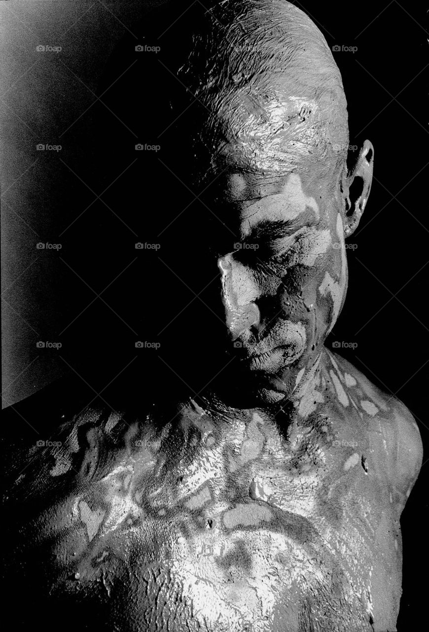 Man covered in clay, moody black and white, shot with Minolta X700 camera, ilford 100 b/w film 