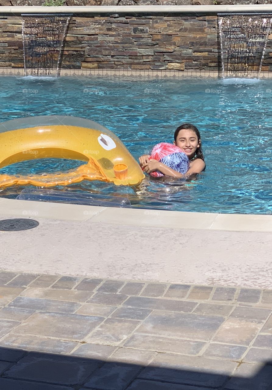 Ashley having fun in our pool after school. 