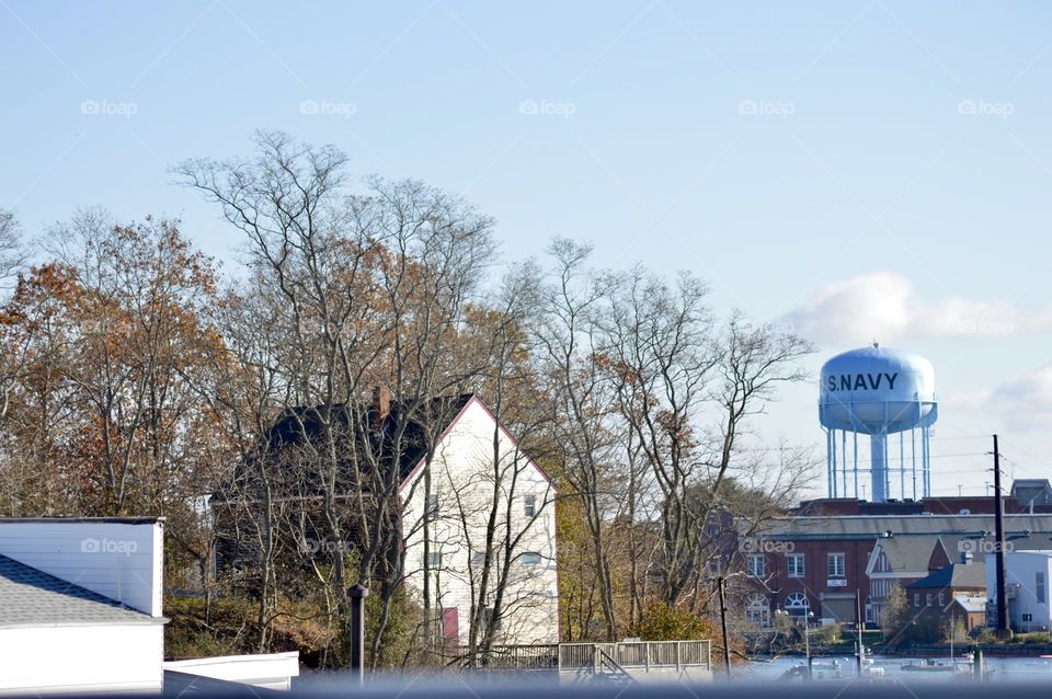 Navy water tower behind a house in Maine 