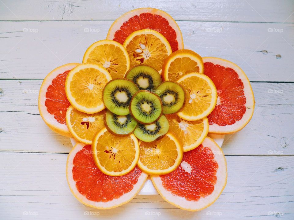 sliced ​​grapefruit, orange and kiwi