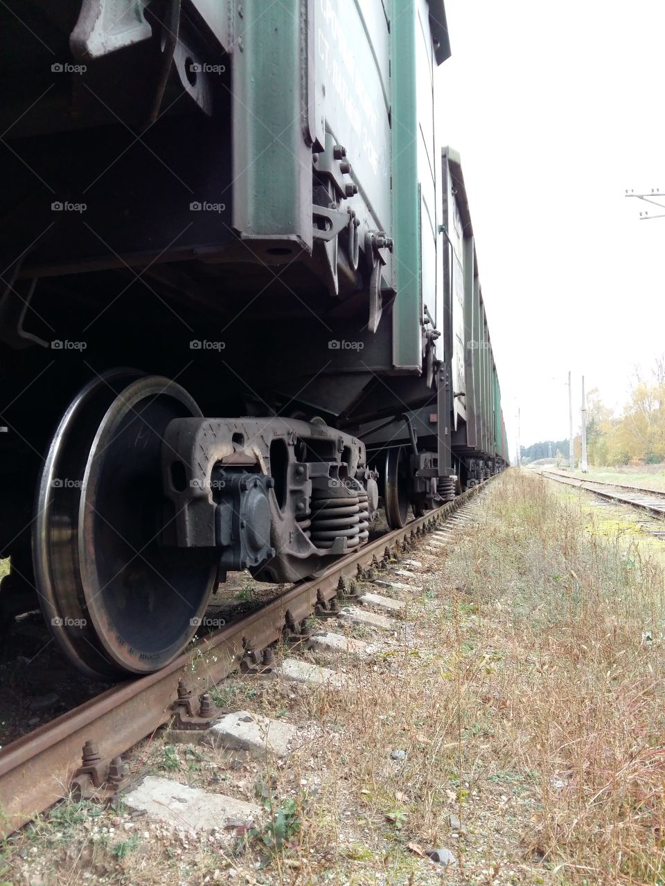 Railway truck closeup on the rails with big wheels