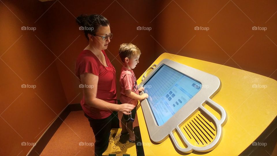 Mother and son in front of technology