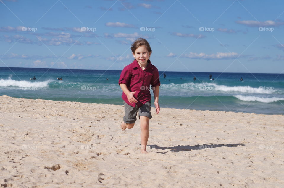 Girl running on sandy beach