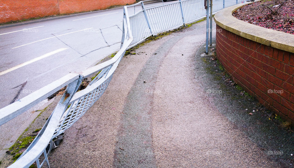 A metal fence damaged by a recent road accident, Wales