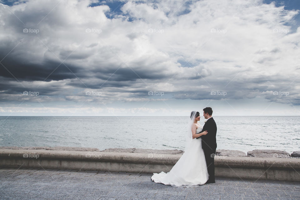 Bride and groom against stormy background