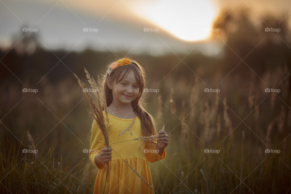 Little girl in yellow dress outdoor portrait 