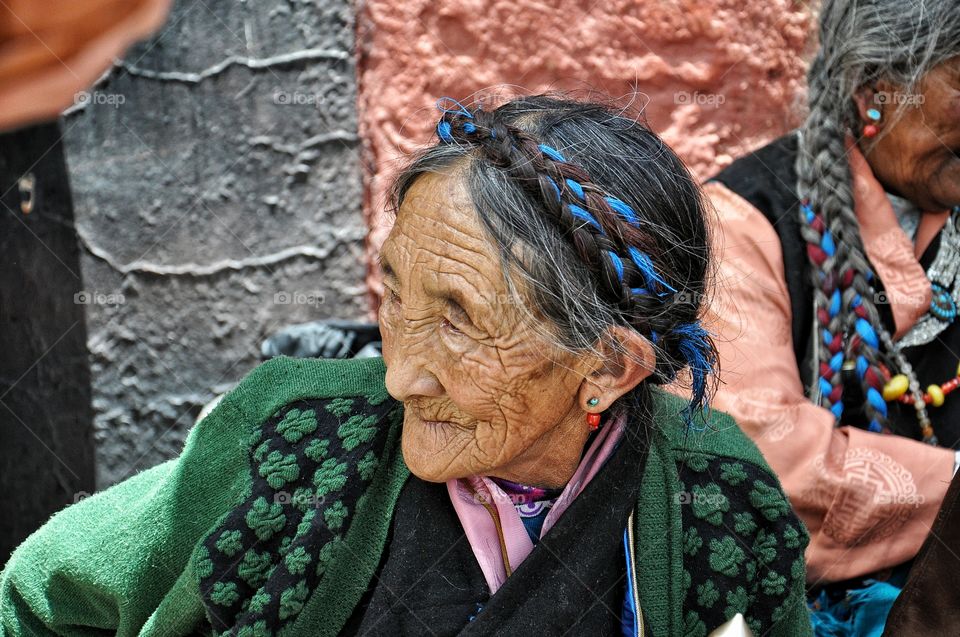 old woman during buddhist holiday in shigatse monastery in tibet