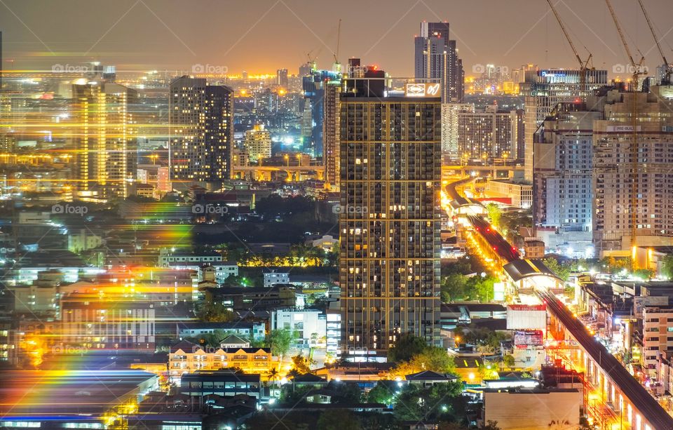 Night light and reflection of skyscraper in Bangkok Thailand