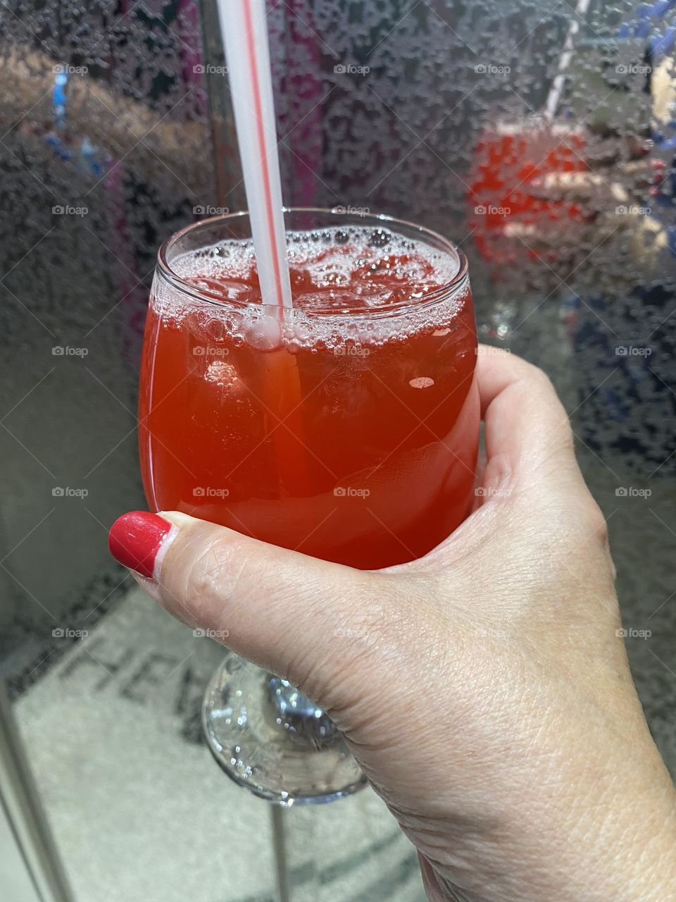 Hand holding glass with cocktail 