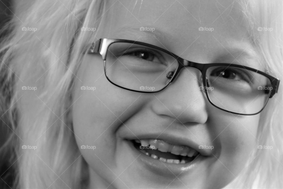 Close-up of a happy girl wearing spectacles