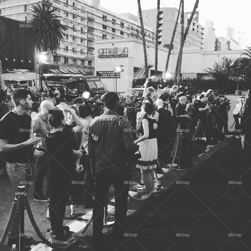 Red Carpet Hollywood Movie Premiere in Black and White with Paparazzi and Flashing Cameras