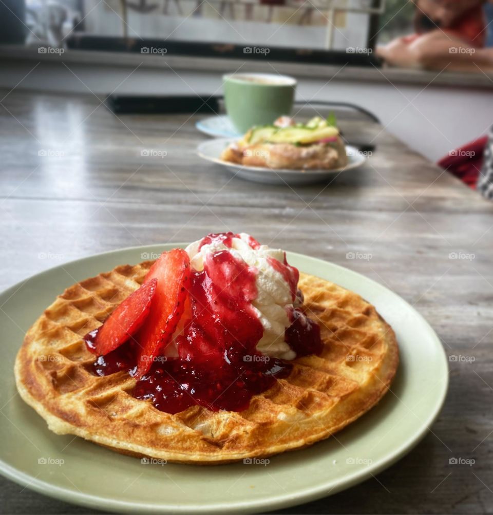 Waffel with cream, jam and stawberries
