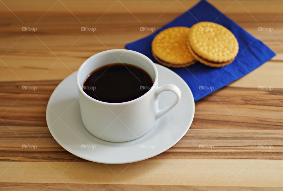 black coffee with cookie on served table