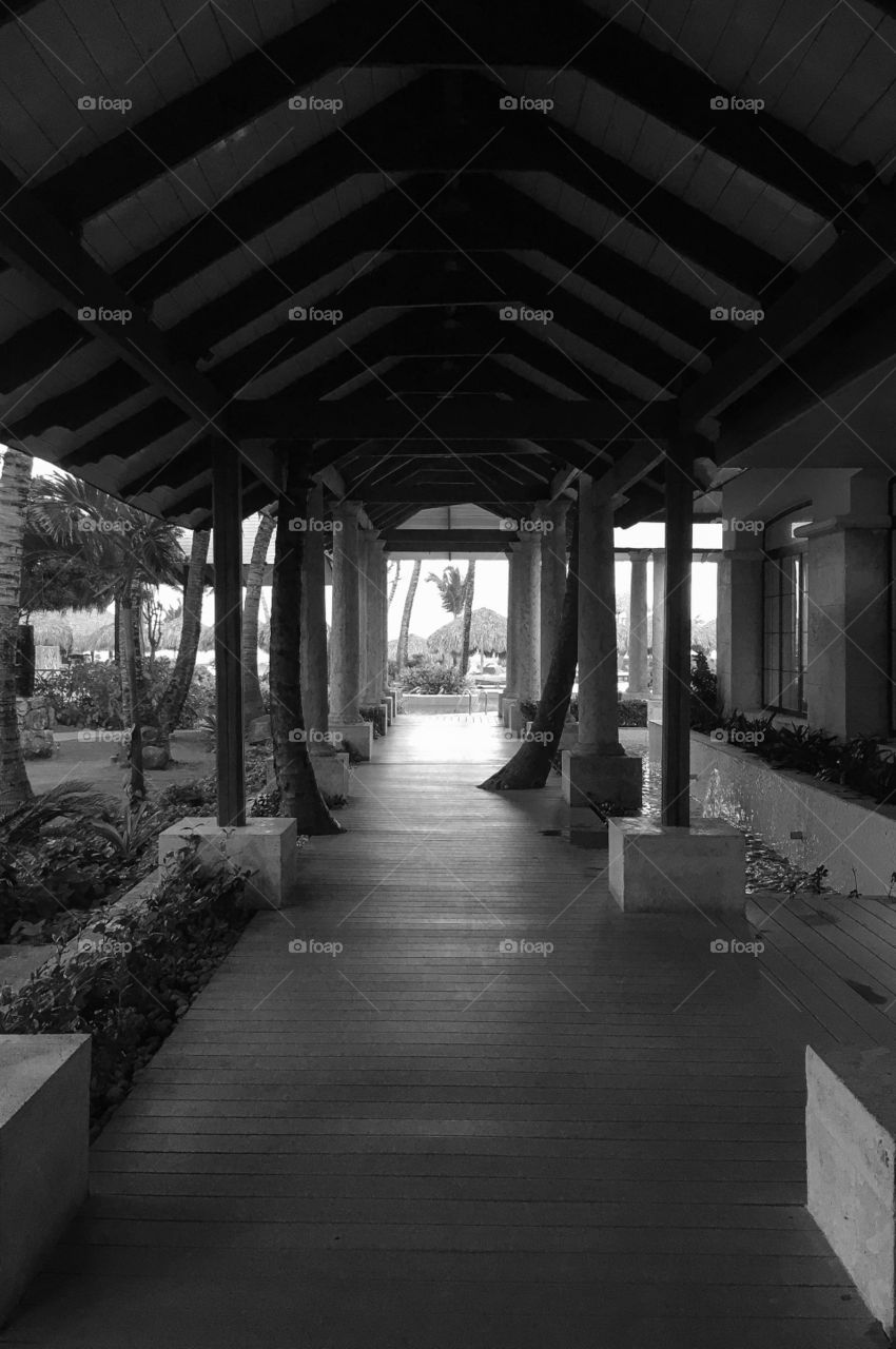 Walk to the light...an outdoor hallway at a tropical resort that leads to the main pool. 