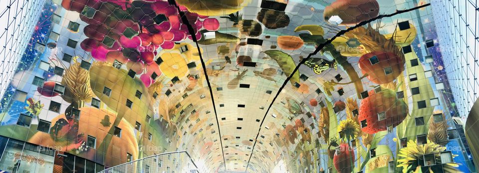Rotterdam local Market called Markthal. The Building has a colorful ceiling.