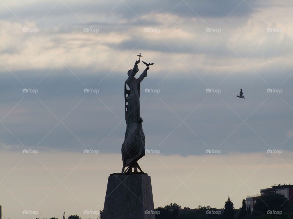 statue freedom jesus cross by byg