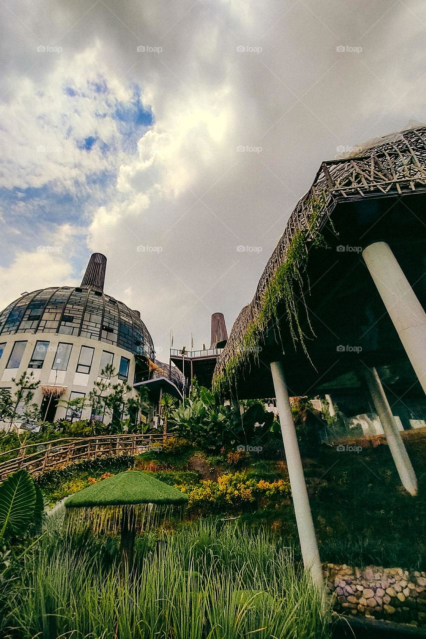 Recreational park with unique buildings. Park. Garden. Playground. Play. Recreation. Holiday. Sky. Cloud. Cloudy. Overcast. Grow. Plant. Leaf. Green. Building. Fresh. Freshness. Relax. Refreshing.