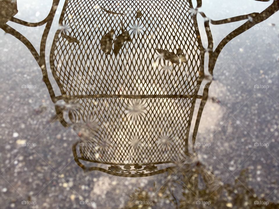 Reflection of a chair after an autumn rain