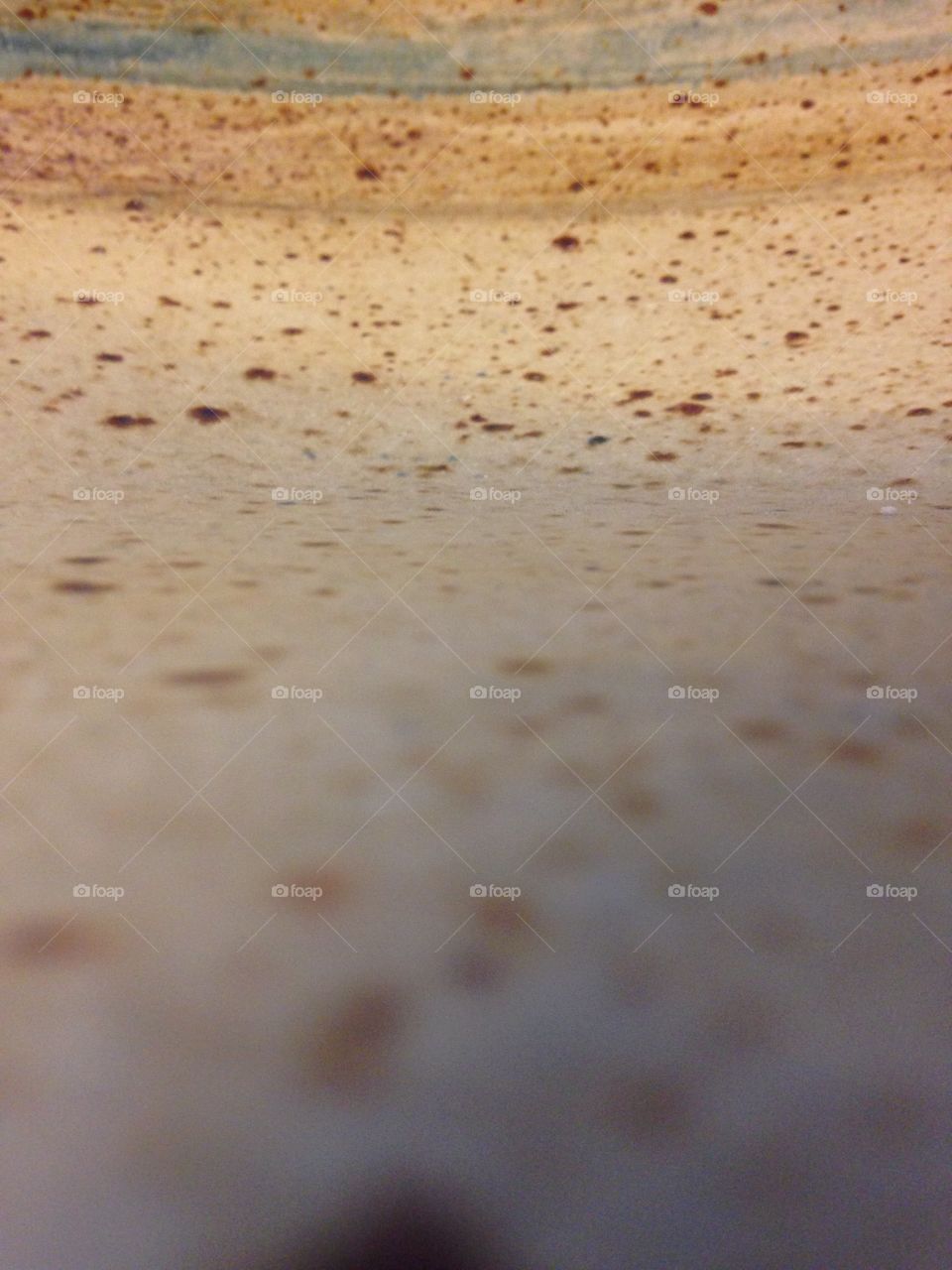 Partly out of focus, speckled glazed pottery texture