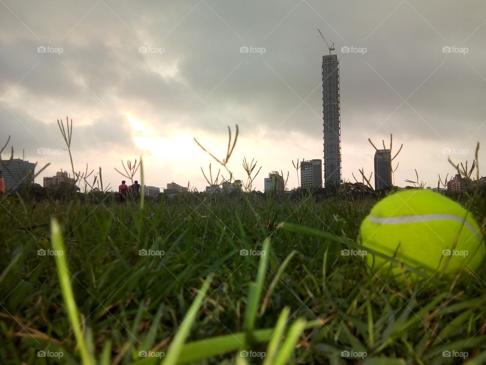 Early Morning Picture Of A Play Ground With A Tallest Building.