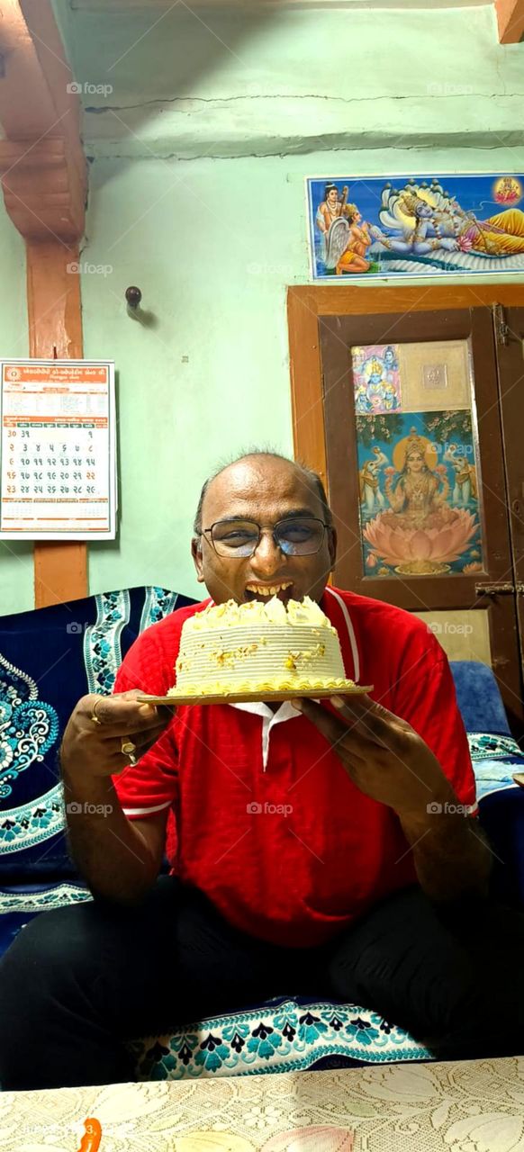 man so happy for cutting a birthday cake so enjoy a movement at home also nice cake