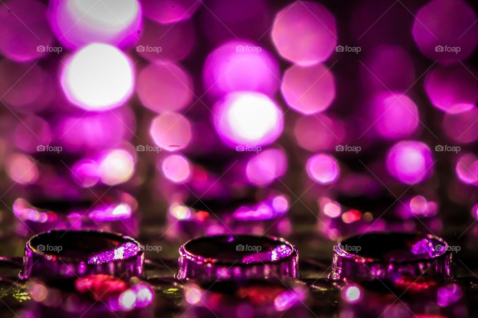 This closeup of a backlit purple mesh of round jewels produces a beautiful soft, symmetrical and hazy purple glow to the whole image. 