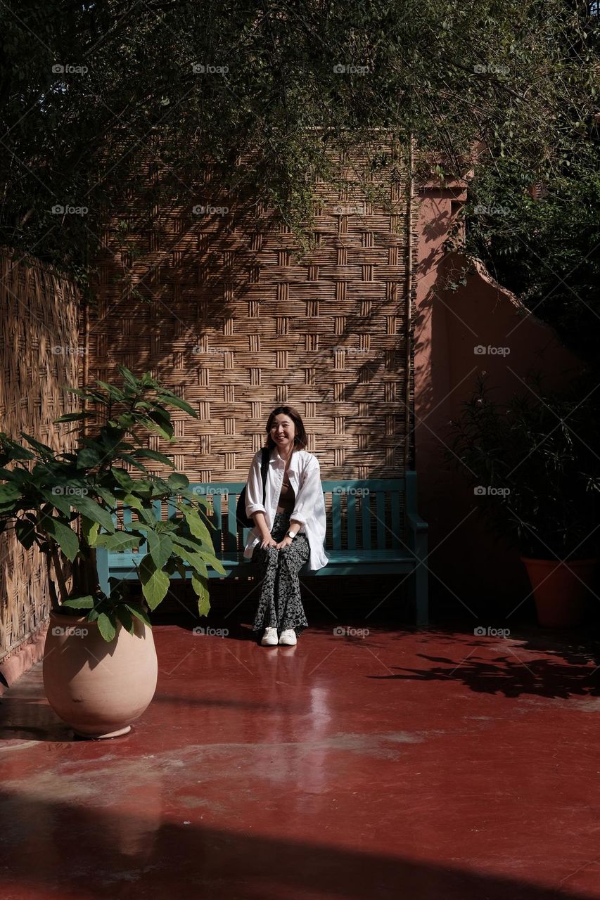 Sitting on the bench in a garden