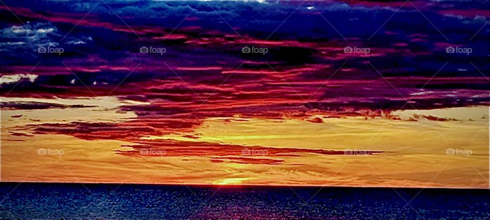 A fiery sunset over the ocean in “Vorpommern”, “Pre Pommerania”, a county in Germany’s North-East that was in “East Germany” prior to the country’s reunification in October 1989. 2022. Hypnotic Productions