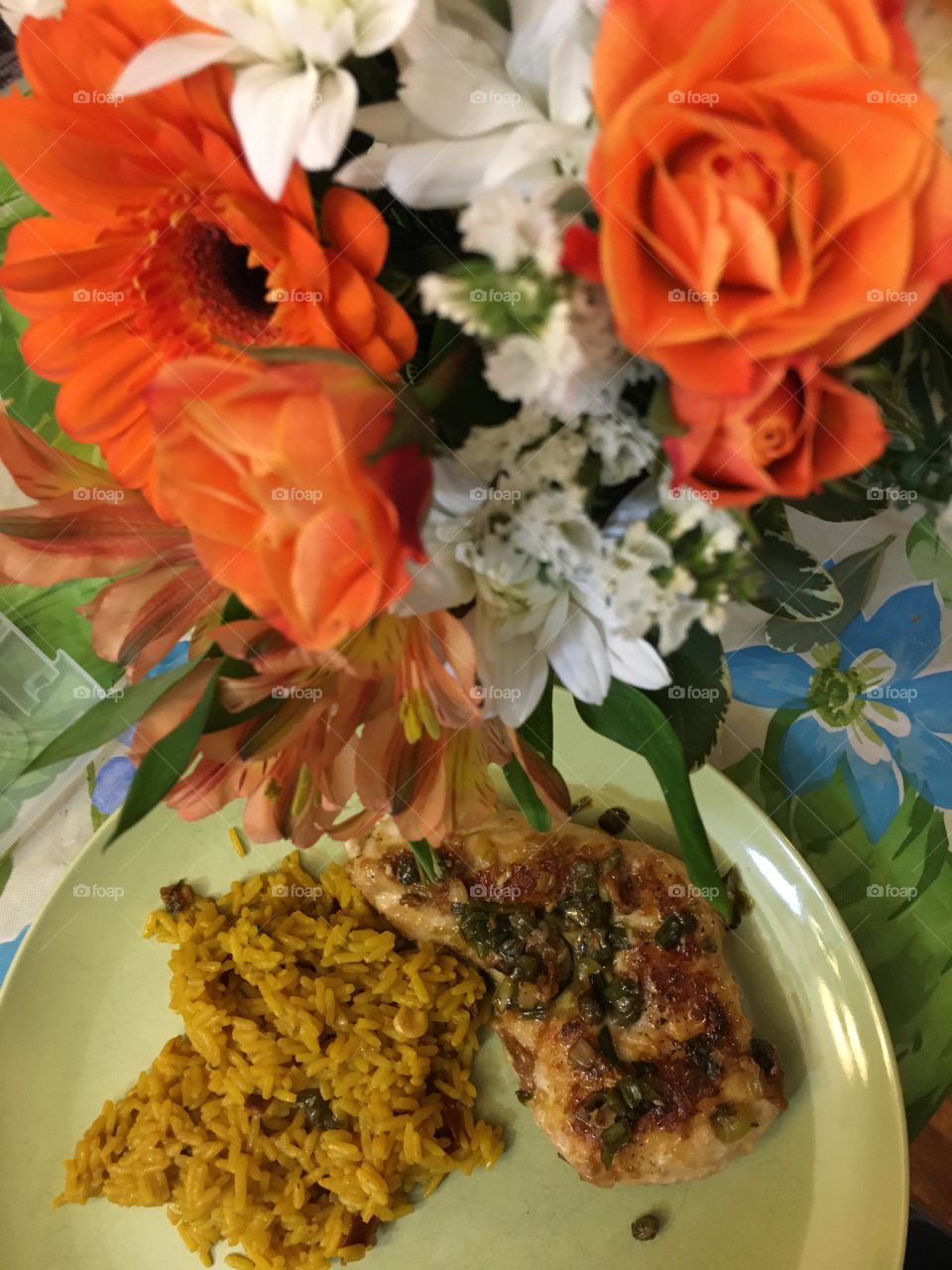 Chicken piccata and rice on a plate