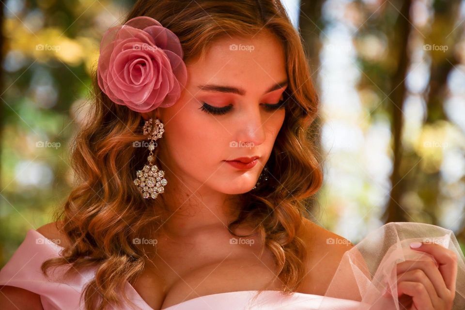 Beautiful woman in pink with gorgeous  sparkling earrings on